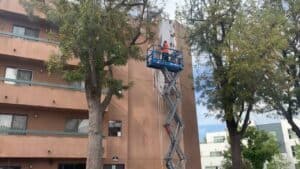 putting detergent on high rise building when washing